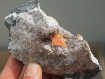 Orange to red calcite on smoky quartz