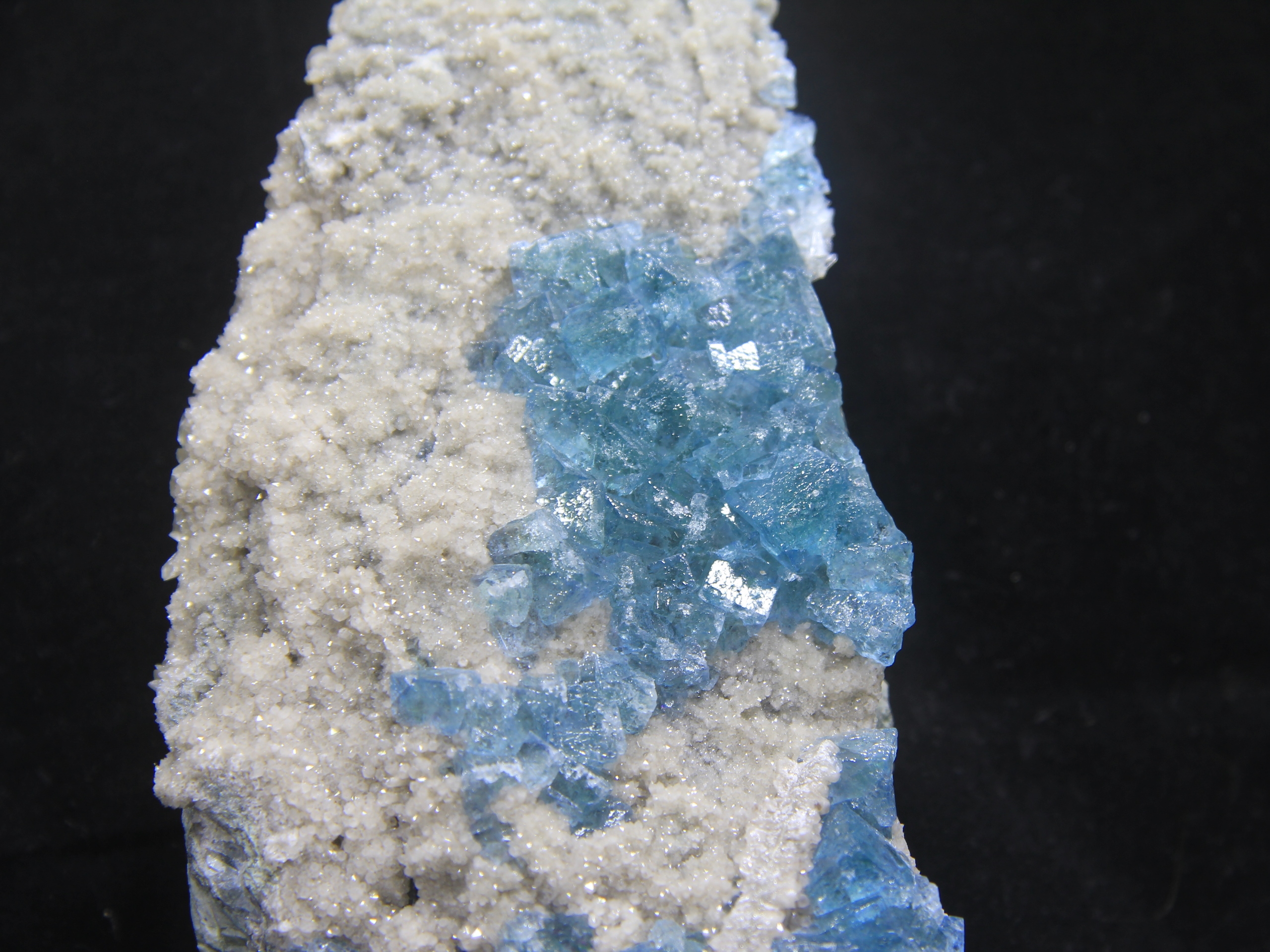 Sea blue fluorite on small crystallized quartz