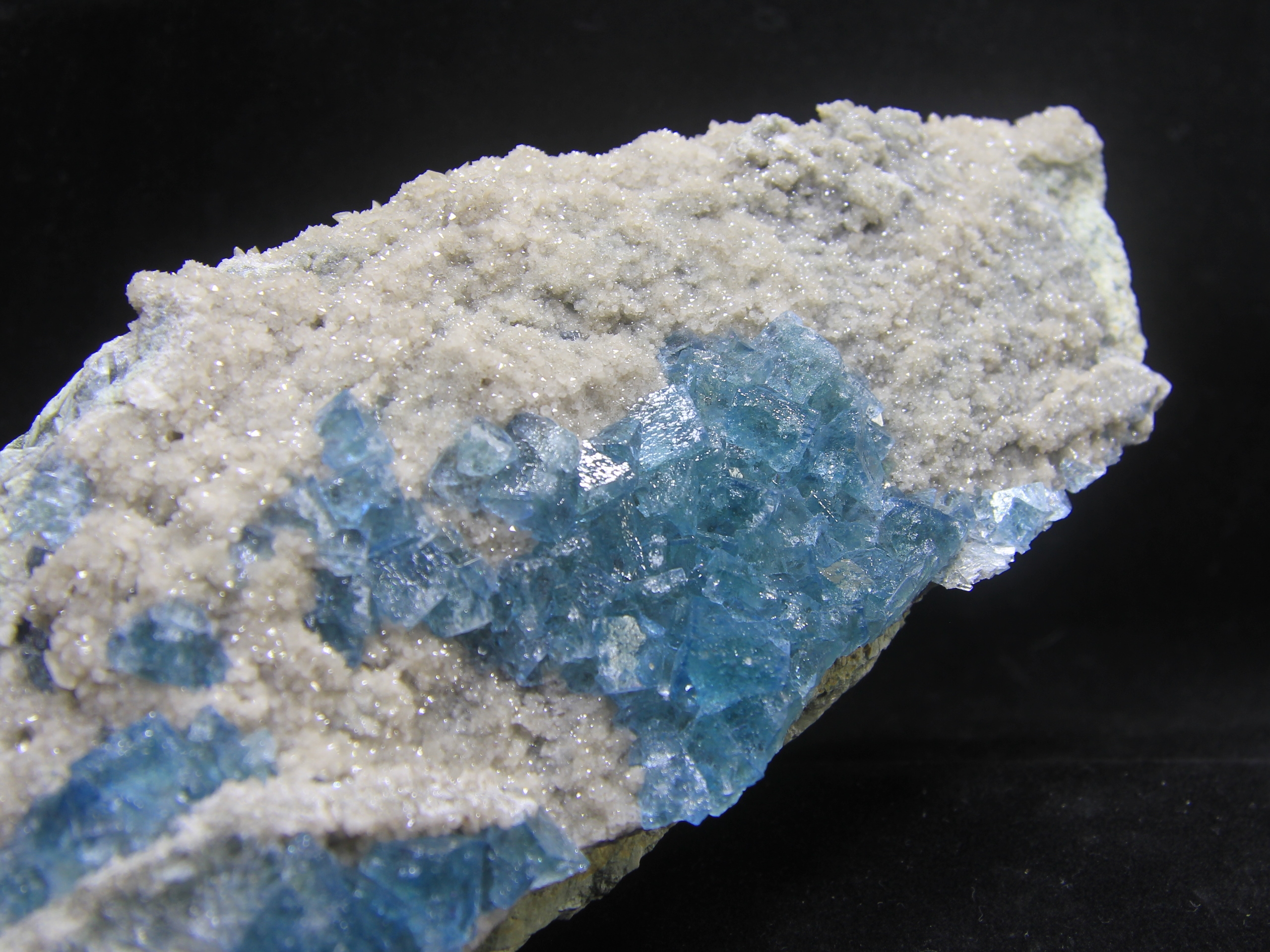 Sea blue fluorite on small crystallized quartz